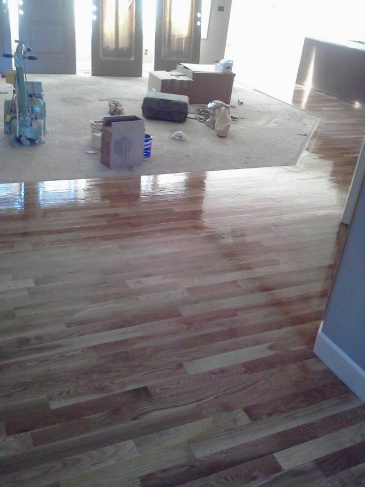 Hardwood Installed, Sanded, Clear coat of poly.